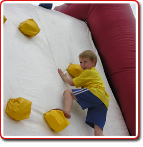 kid on inflatable rock wall